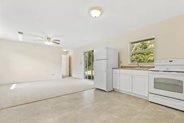 a view of a kitchen with a sink dishwasher and a fireplace