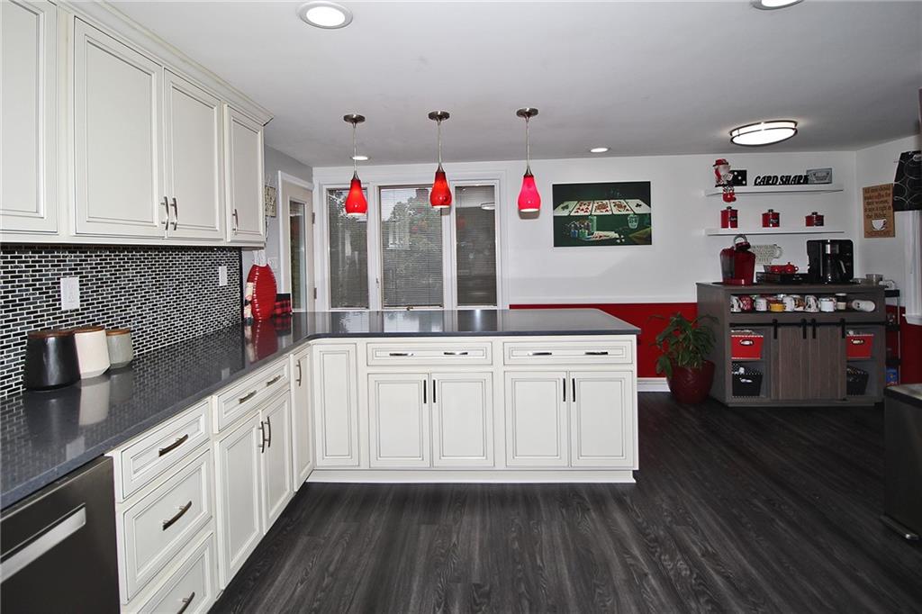 21 Meadowcrest Drive Cecil, PA 15321 - Photo 3 of 36 a kitchen with granite countertop a white cabinets and wooden floor