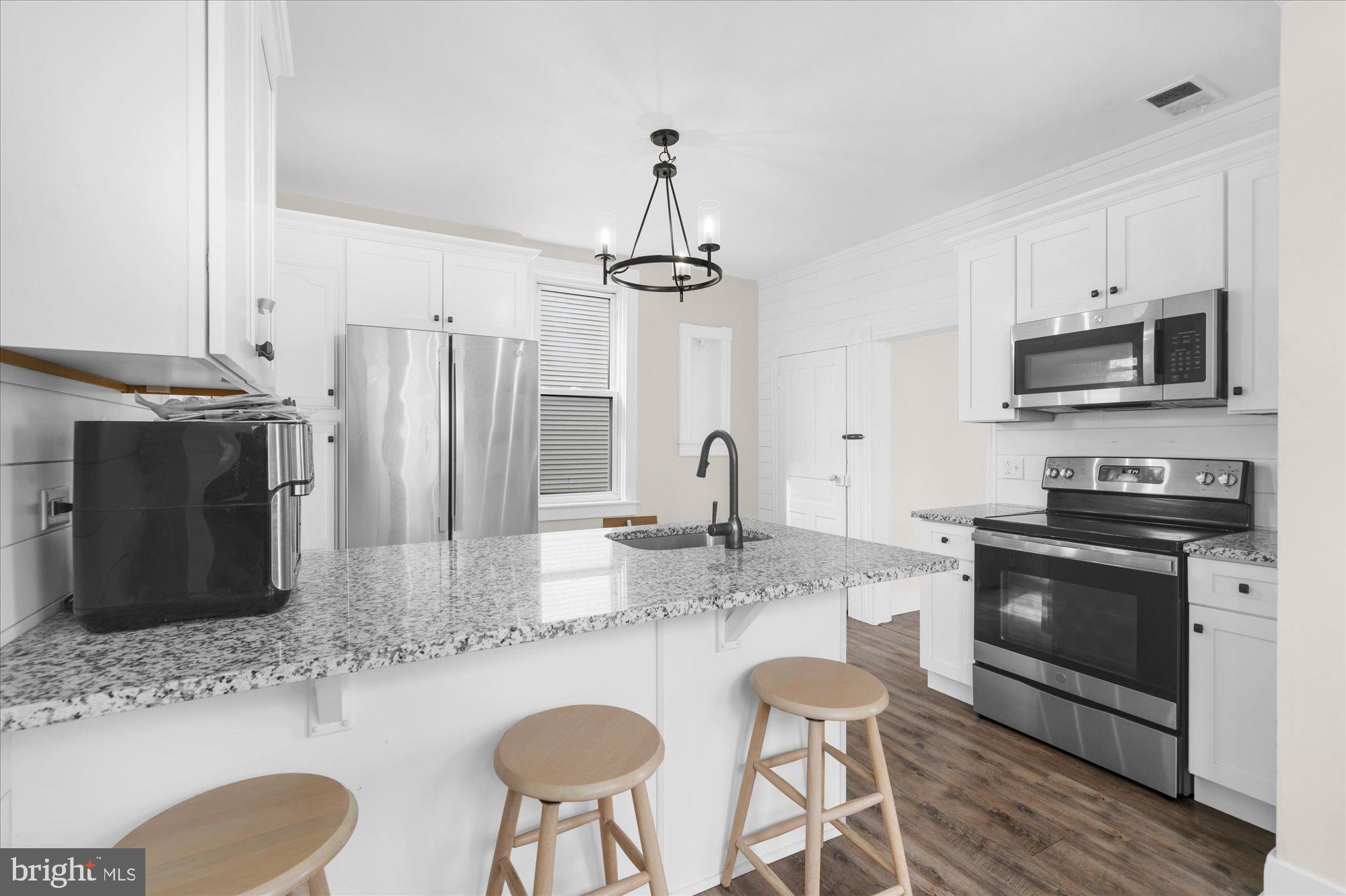 109 New Holland Avenue Reading, PA 19607 - Photo 11 of 36 a kitchen with stainless steel appliances granite countertop a stove a sink dishwasher a refrigerator with a dining table and chairs