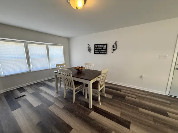 a view of a dining room with furniture and window