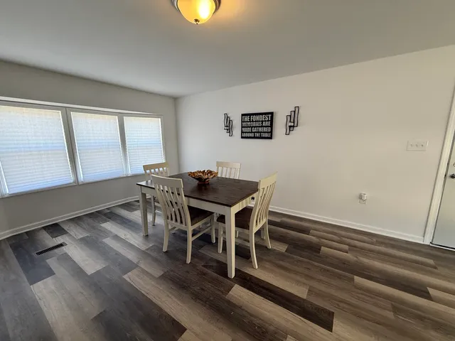 a view of a dining room with furniture and window