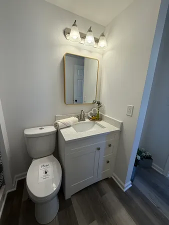 a bathroom with a toilet sink and mirror