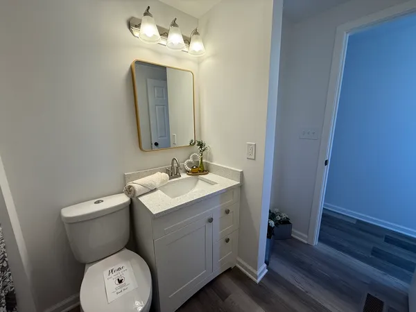 a bathroom with a toilet sink and mirror