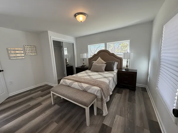 a bedroom with a bed and a window