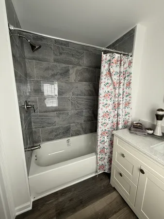 a bathroom with a bathtub and a shower