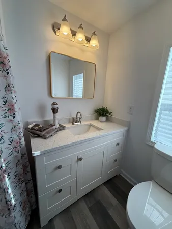 a bathroom with a toilet sink and mirror