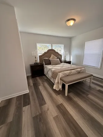 a bedroom with a bed and a night stand