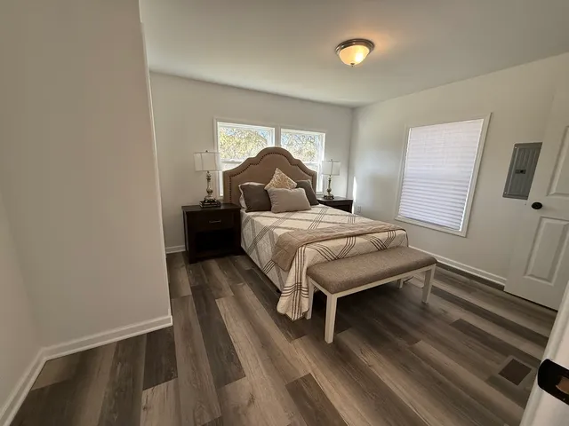 a bedroom with a bed and window