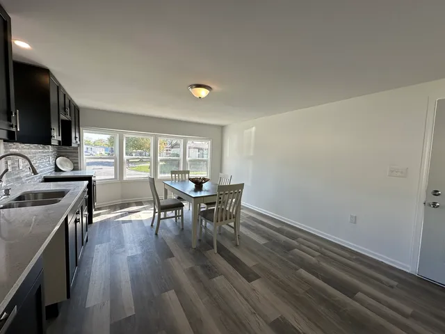 a view of a dining room with furniture and a window