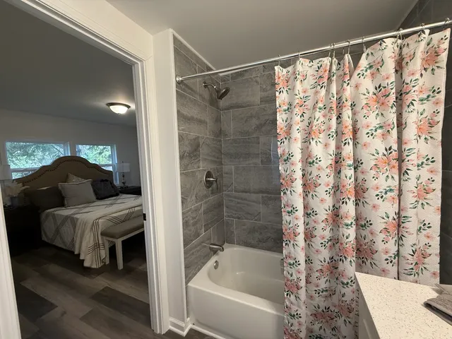 a en suite bathroom with a bathtub and shower