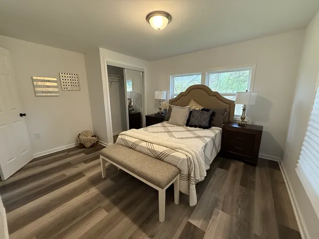 a bedroom with a bed and a chandelier