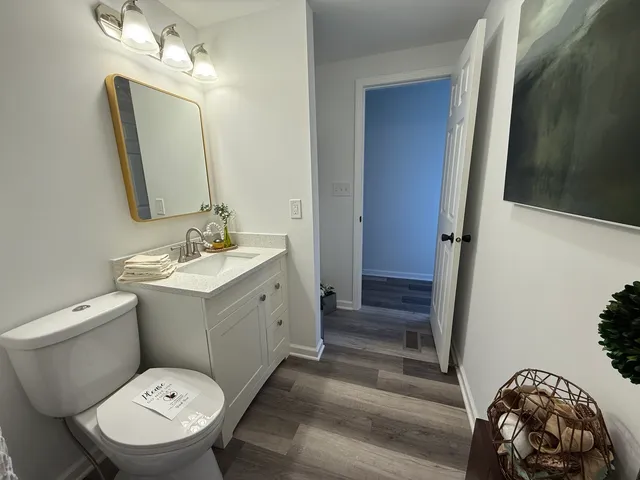 a bathroom with a toilet sink and mirror