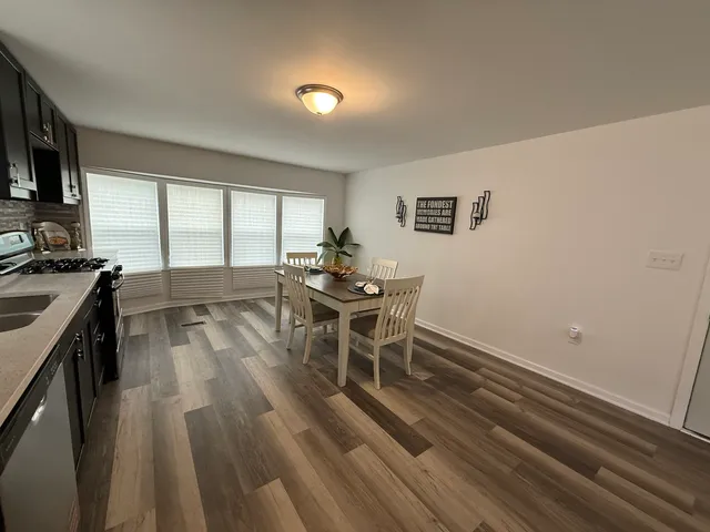 a dining room with furniture and a kitchen view