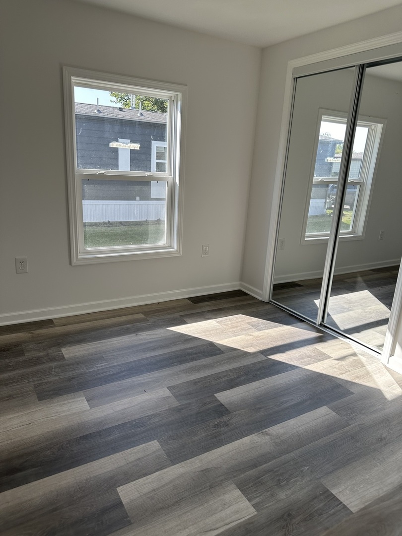 241 Blackthorn Road Matteson, IL 60443 - Photo 6 of 41 a view of an empty room with wooden floor and a window