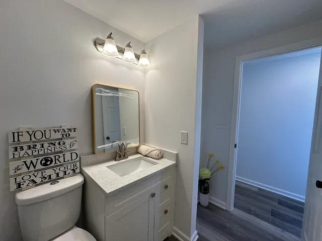 a bathroom with a toilet sink and mirror