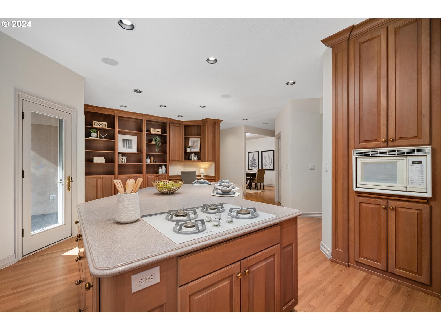 4083 Southeast Augusta Loop Gresham, OR 97080 - Photo 17 of 48 a living room with stainless steel appliances kitchen island granite countertop furniture and wooden floor