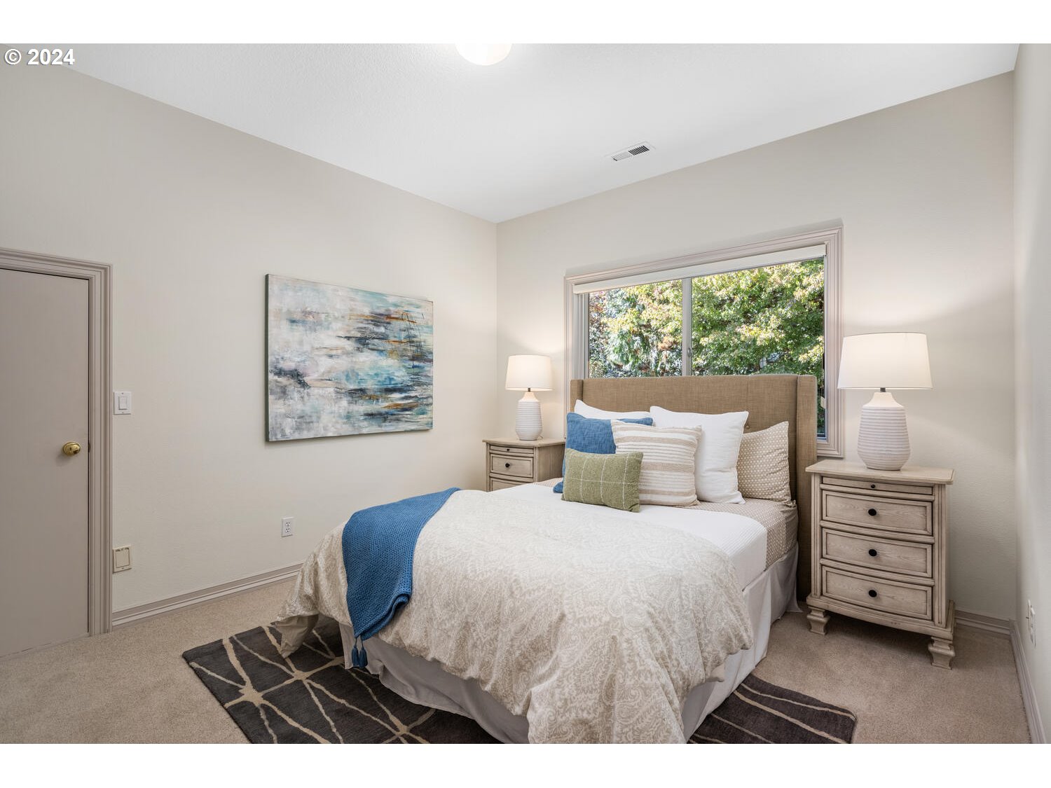 4083 Southeast Augusta Loop Gresham, OR 97080 - Photo 31 of 48 a bedroom with a bed a dresser and a window