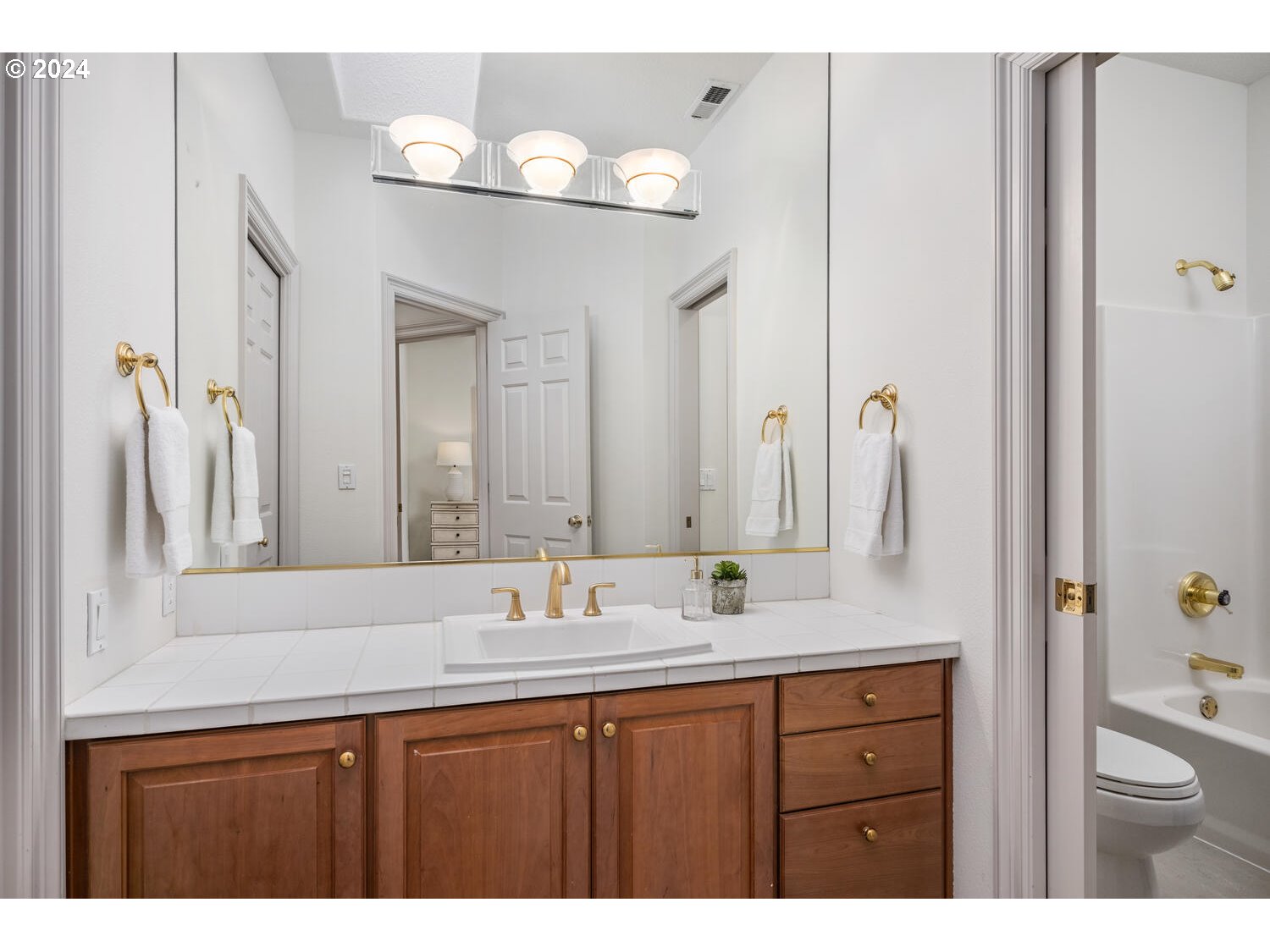 4083 Southeast Augusta Loop Gresham, OR 97080 - Photo 33 of 48 a bathroom with a granite countertop sink and a mirror