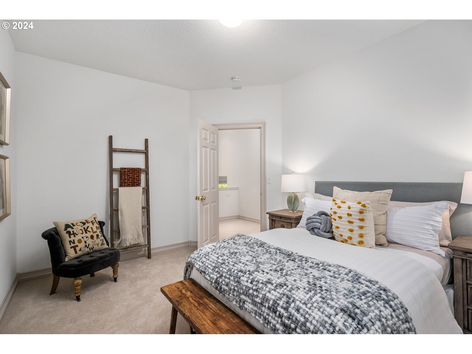 4083 Southeast Augusta Loop Gresham, OR 97080 - Photo 37 of 48 a bedroom with a bed and a chair