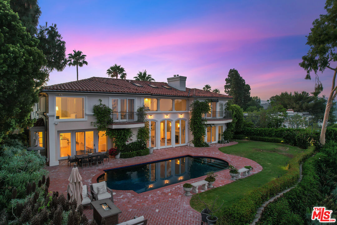 a view of a house with swimming pool yard and outdoor seating