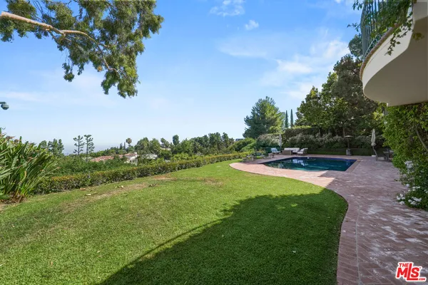 a bedroom with a bed a flat screen tv and a couch