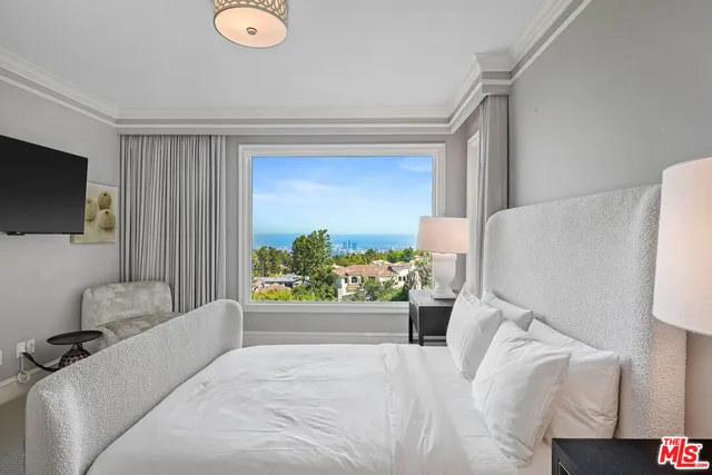 a bedroom with a bed and a potted plant