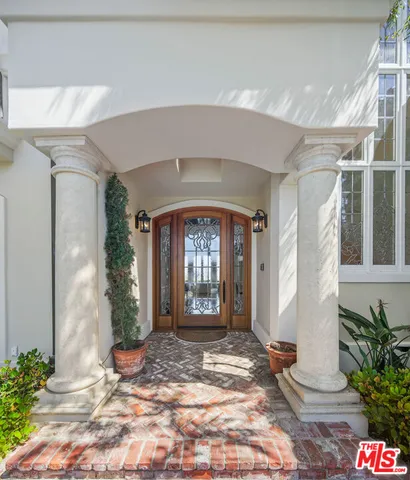 a tree in front of a white house