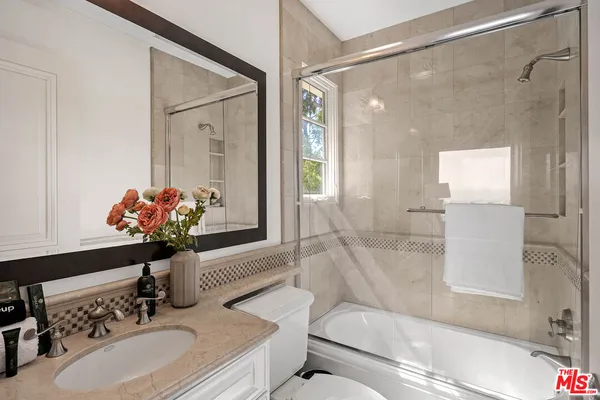 a bedroom with a large bed and a view of bedroom