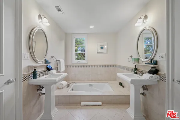 a front view of a house with a garden and a yard