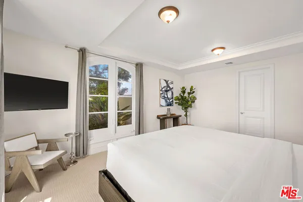 a living room with furniture a fireplace and a floor to ceiling window