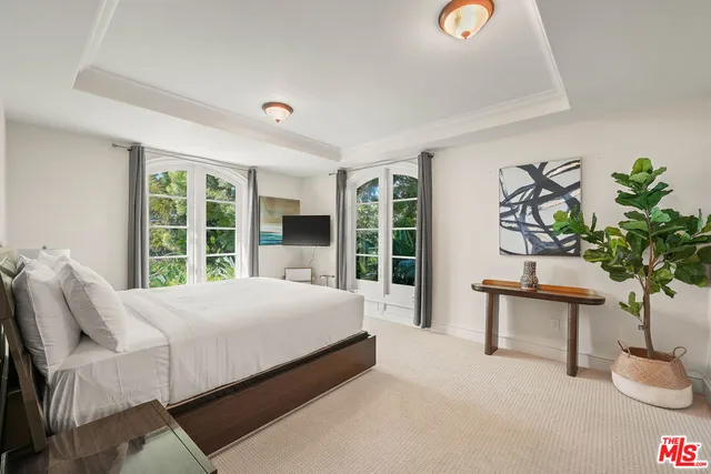 a spacious bathroom with a granite countertop tub shower and mirror