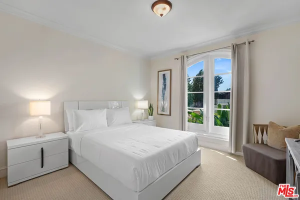 a kitchen with white cabinets and sink