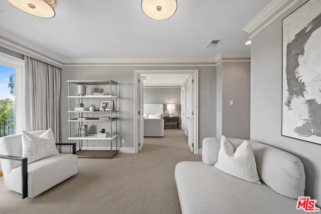 a spacious bedroom with a large bed and a flat tv screen