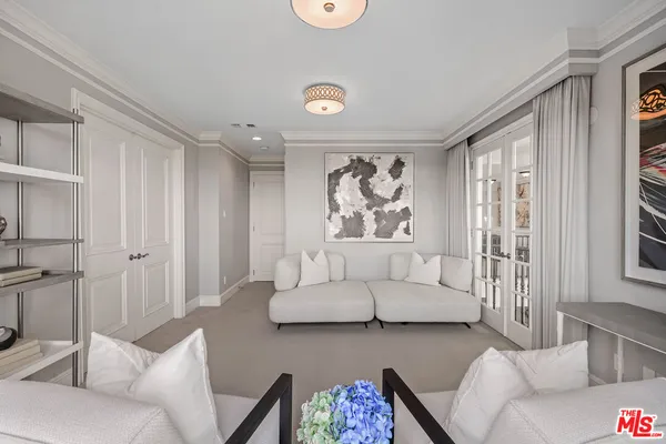 a spacious bedroom with a bed and a flat screen tv