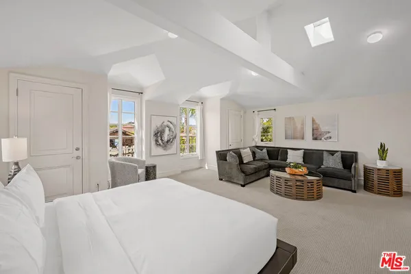 a living room with furniture floor to ceiling window and wooden floor