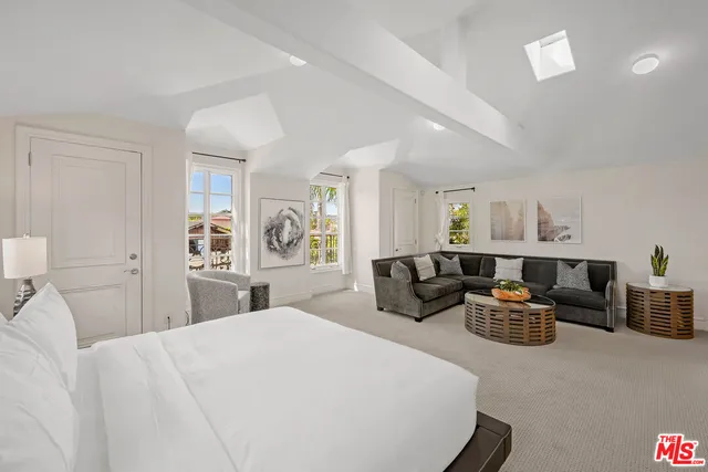 a living room with furniture floor to ceiling window and wooden floor