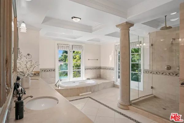 a living room with furniture fireplace and a large window