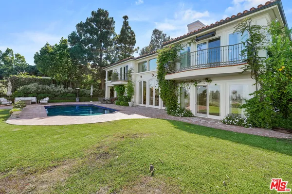 a a spacious bedroom with a bed and a large window
