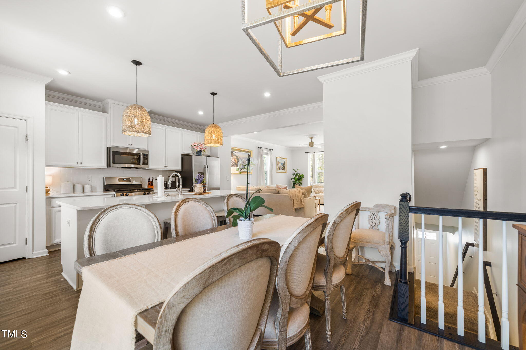 4724 Randall Road Durham, NC 27707 - Photo 6 of 47 a very nice looking dining room with kitchen island furniture a fireplace and a chandelier