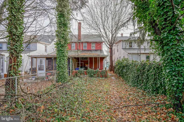 a red brick house with trees in front of it