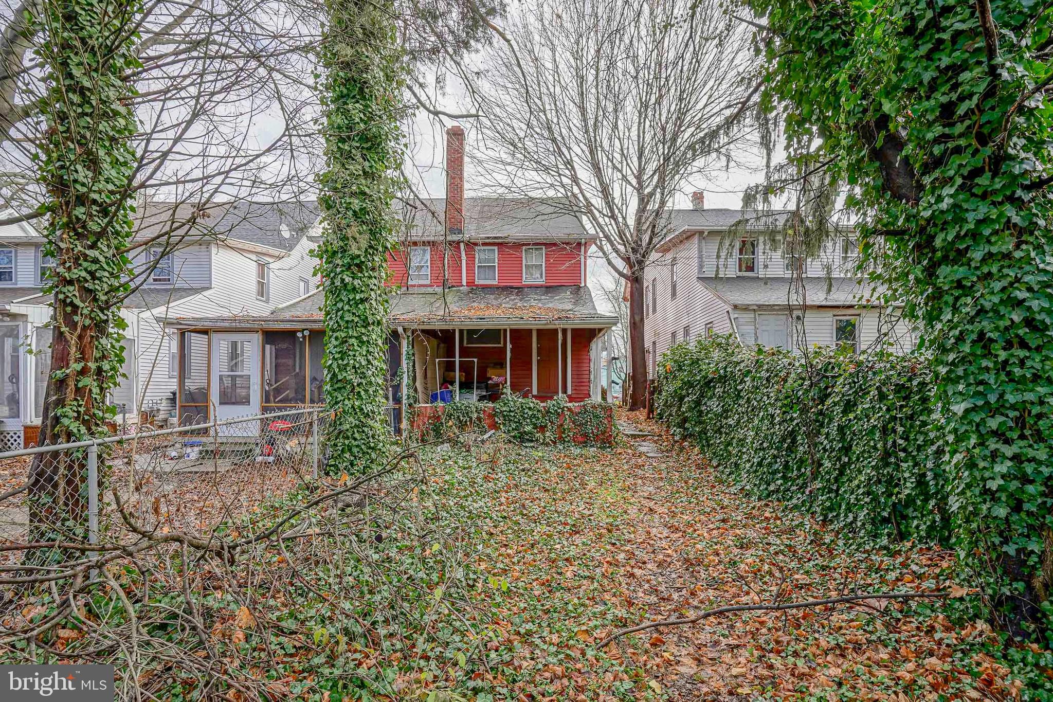 79 Walnut Street Salem, NJ 08079 - Photo 4 of 4 a red brick house with trees in front of it