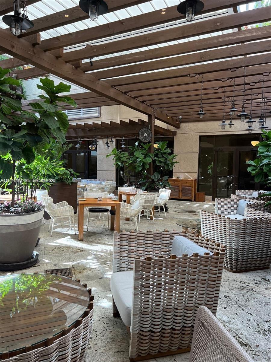 3400 Southwest 27th Avenue, Unit 1105 Miami, FL 33133 - Photo 23 of 24 a building outdoor space with patio furniture and potted plants