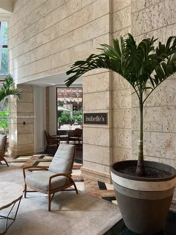 a building outdoor space with patio furniture and potted plants