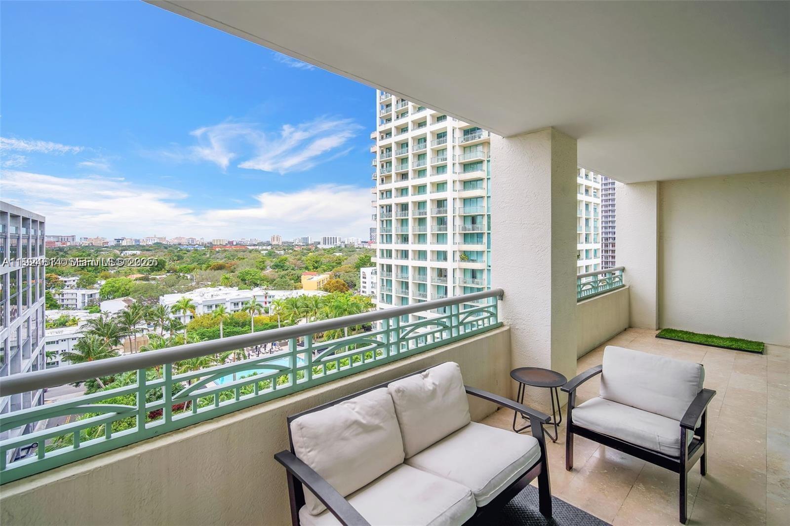 3400 Southwest 27th Avenue, Unit 1105 Miami, FL 33133 - Photo 3 of 24 a view of a city from a balcony with furniture
