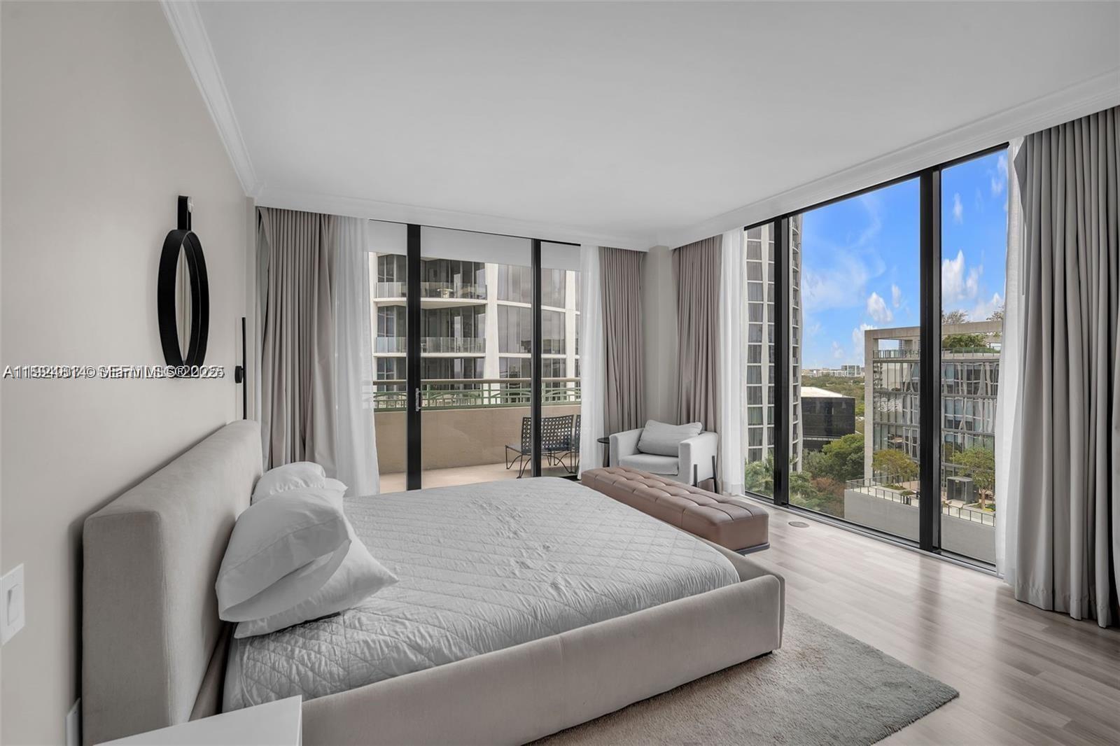 3400 Southwest 27th Avenue, Unit 1105 Miami, FL 33133 - Photo 6 of 24 a bedroom with a large bed and a flat tv screen