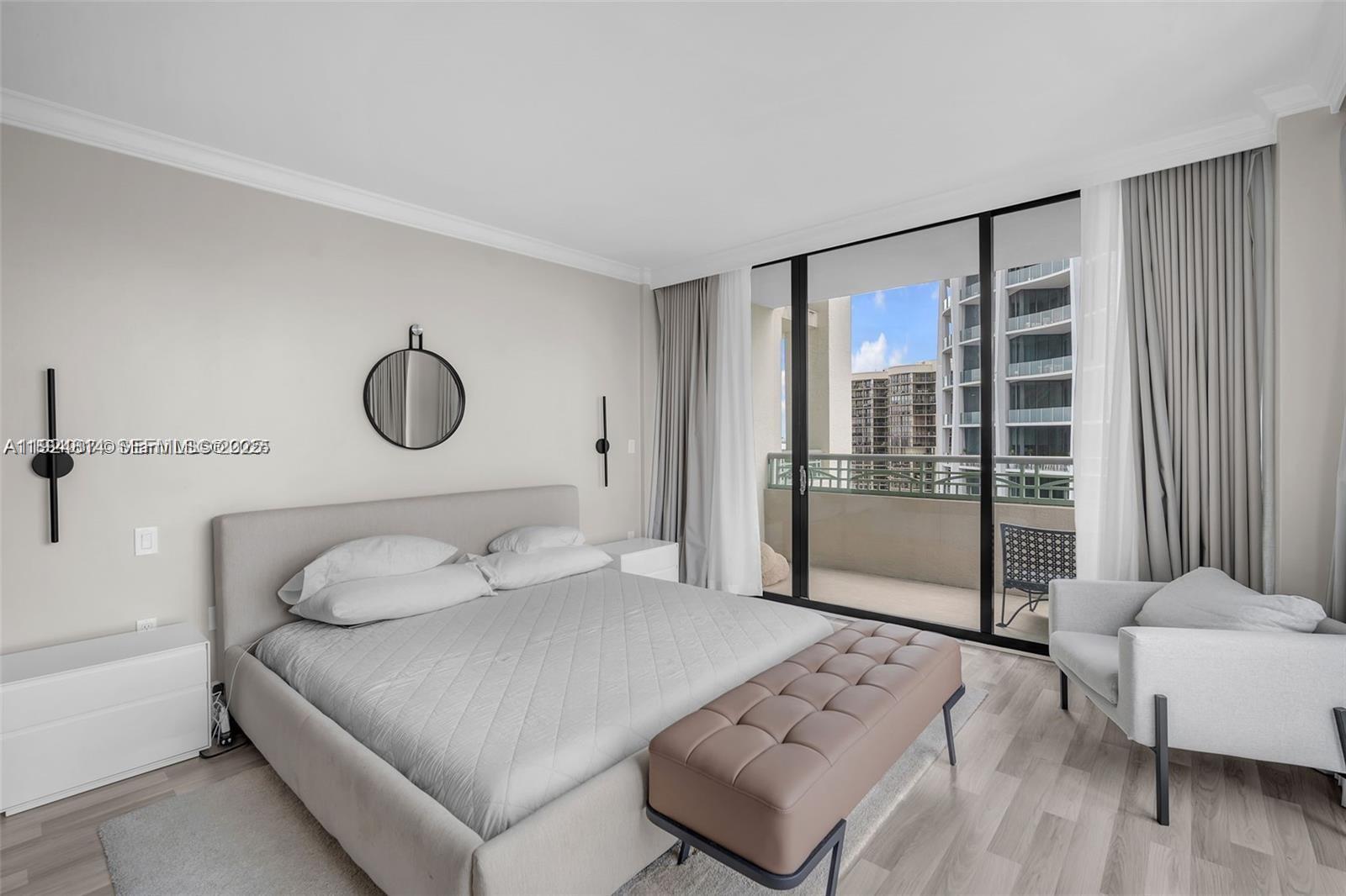 3400 Southwest 27th Avenue, Unit 1105 Miami, FL 33133 - Photo 7 of 24 a bedroom with a large bed and a couch