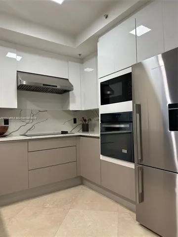 a kitchen with stainless steel appliances a refrigerator and a stove