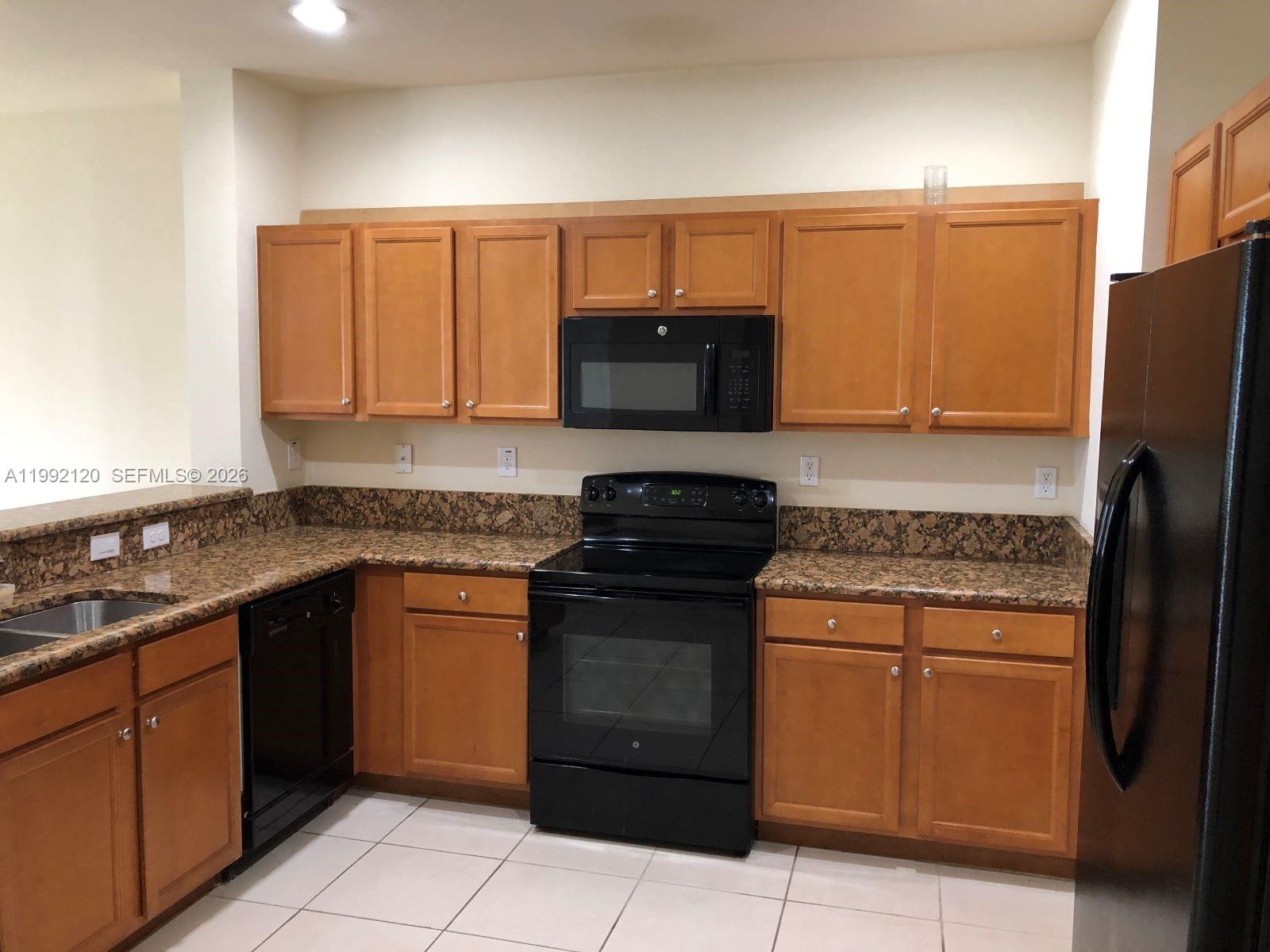 17000 Southwest 90th Terrace Miami, FL 33196 - Photo 32 of 56 a kitchen with stainless steel appliances granite countertop a stove a refrigerator and a sink