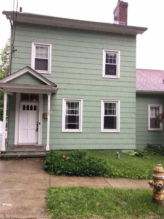 32 Maple Street, Unit 2 Sleepy Hollow, NY 10591 - Photo 1 of 1 a front view of a house with garden