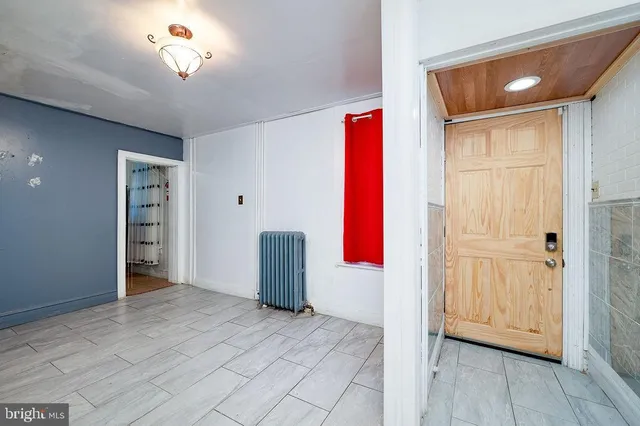 a view of a hallway with fireplace and cabinet